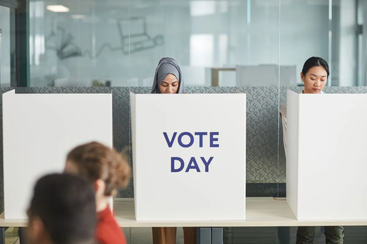 voting booth with Hispanic voters