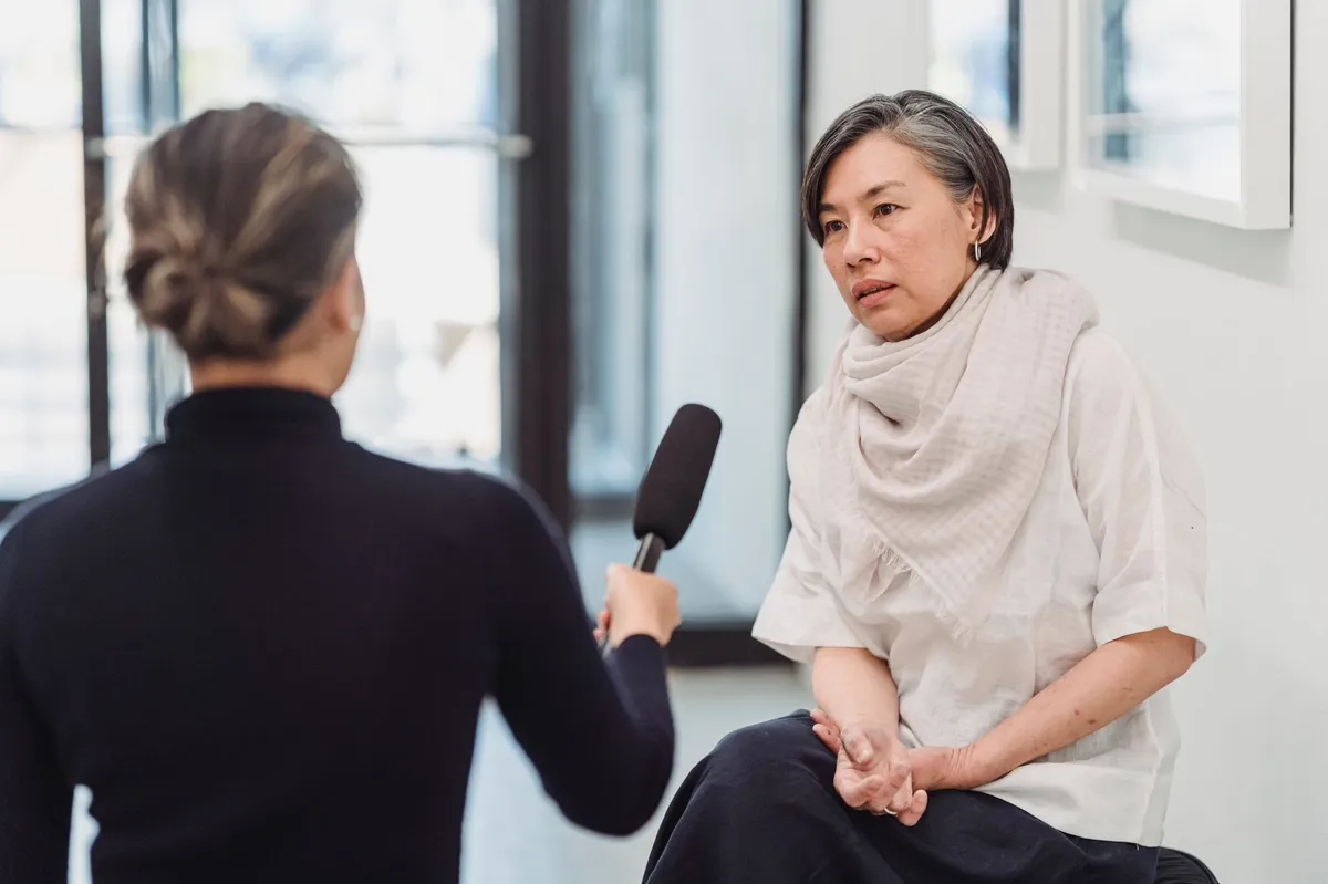 woman speaking to media