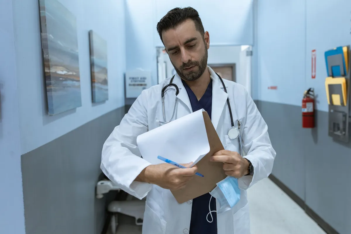 physician reading contract