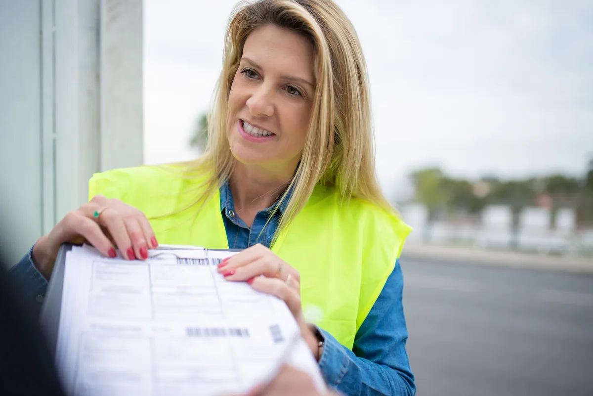 postal service worker sorting mail