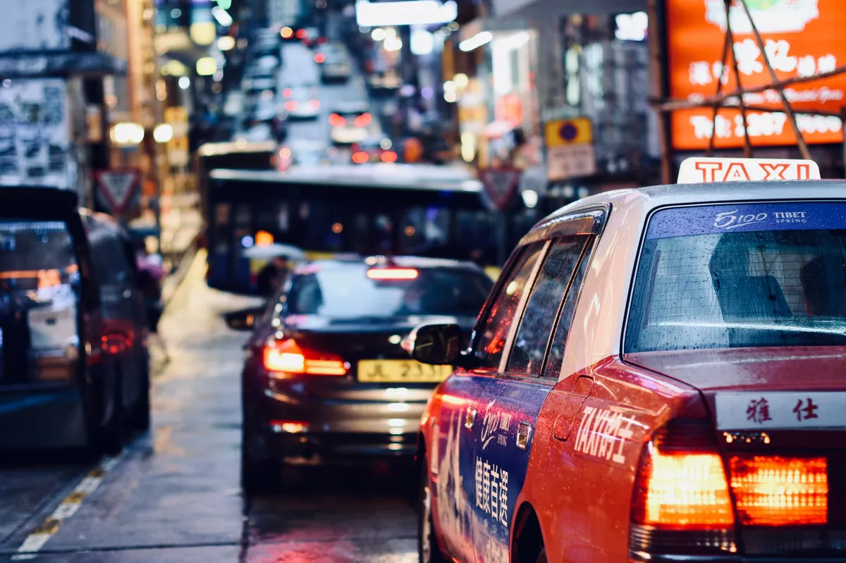 busy city street with rideshare vehicles