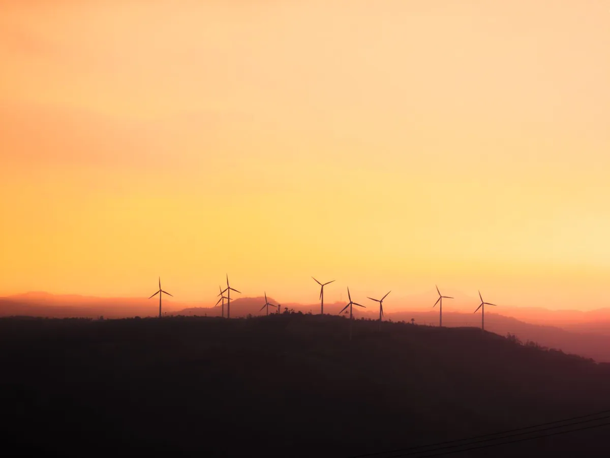 wind turbines against the sunset