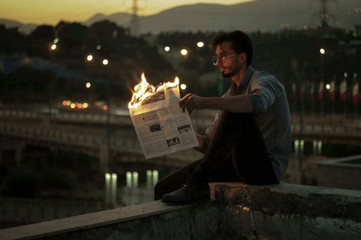 man holding burned arm