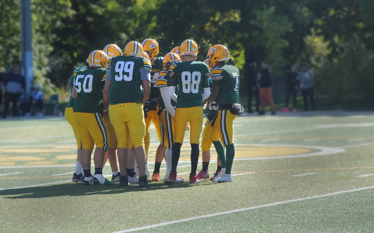 football players in huddle