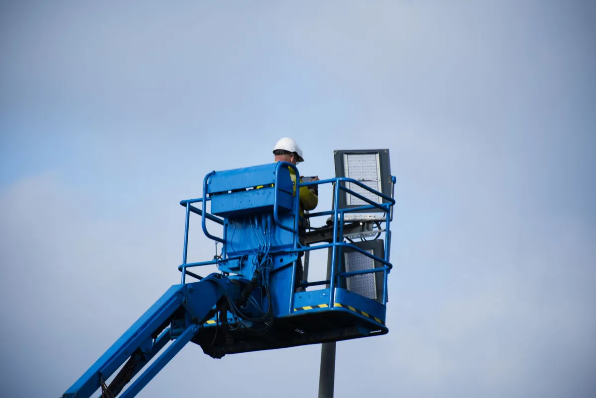 construction worker operating aerial lift
