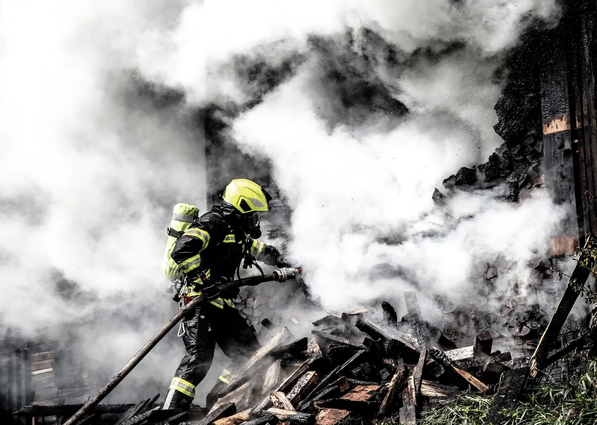 firefighter battling wildfire