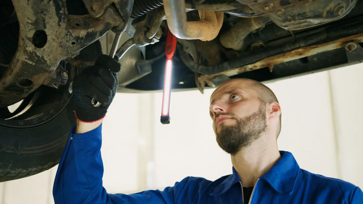 mechanic inspecting car camera
