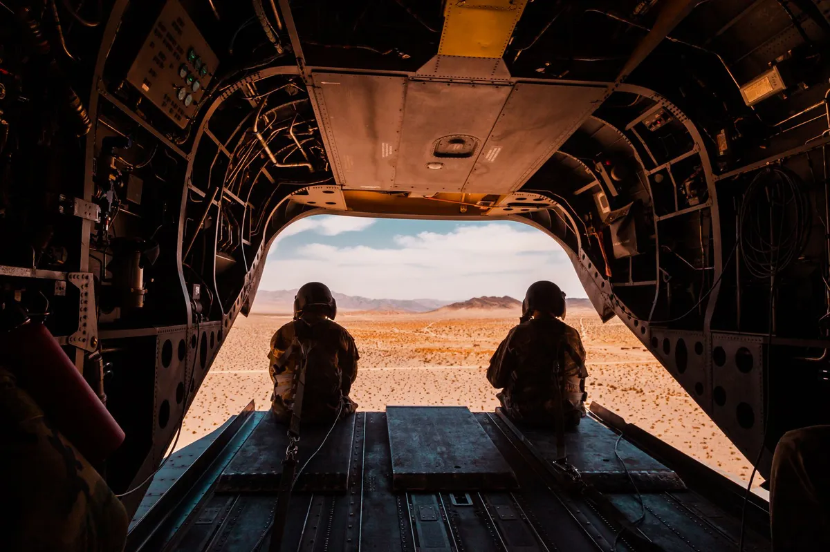 military aircraft over desert landscape