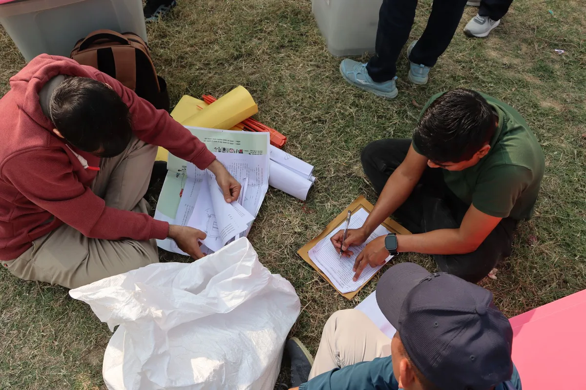 election officials preparing ballots